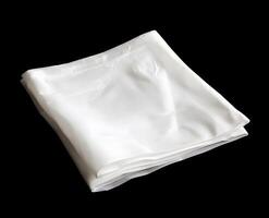 Folded white fabric against a black background. photo