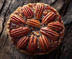 Pecan pie tart on a rustic wooden surface. photo