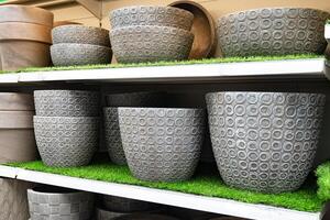 Textured stone planters displayed in a garden store. photo