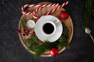 A top-down view of a cozy holiday scene showcasing festive elements like candy canes arranged in a heart, photo