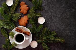Close-up of a Christmas table arrangement with candy canes in the shape of a heart, gingerbread cookies, cinnamon sticks photo