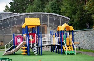 Colorful children's playground in a green park Community game. photo