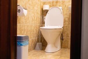 Clean bathroom with white toilet and tiled walls. photo