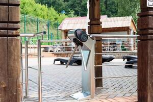 Entrance turnstile gate at swimming pool area on a sunny day. photo