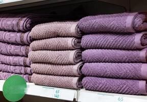 Multi colors Stack of bath towels. towels in a stack on the shelves in the supermarket. family shopping. photo