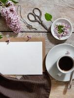 The lighting is soft and natural, casting gentle shadows that emphasize the textures of the paper, wood, and flowers without creating harsh contrasts. photo