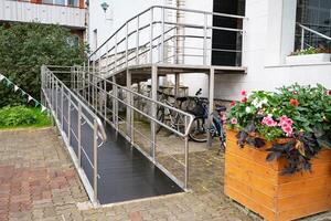 Modern building entrance with wheelchair ramp. photo