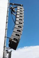 Stage lighting equipment hanging from trusses at an event, photo