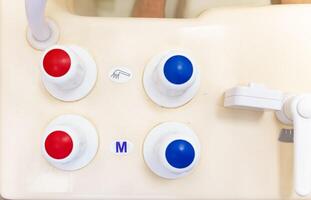 Timer and faucet handles on the bathtub in close-up. Temperature controller for spa treatments. photo