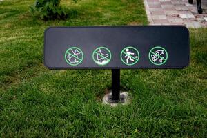 Park sign with prohibitions on activities in green area. photo