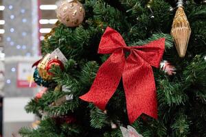 Christmas tree decorations featuring a red bow and ornaments. photo
