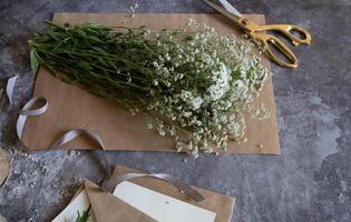 The arrangement suggests a thoughtful, handcrafted invitation or greeting card setting. photo