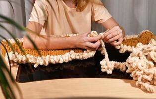 cozy indoor setting, showcasing a person working on a handmade textile piece using modern techniques photo