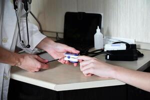 Health check in a medical office as a patient receives examination with a healthcare professional while using a medical device photo