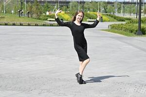 The setting appears to be outdoors, possibly near a modern building or art installation. photo