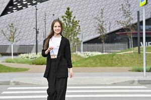 Woman crossing a street on a pedestrian crosswalk in an urban area. photo