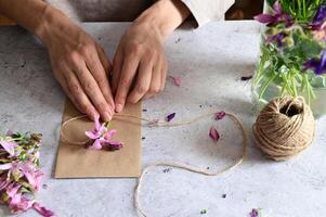 On the left side of the picture, there are several envelopes and cards in neutral tones such as beige and cream, photo
