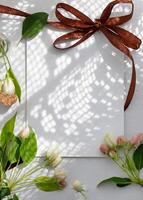Relaxing tea experience with a cup of herbal tea and fresh blossoms on a serene white table setting during springtime photo