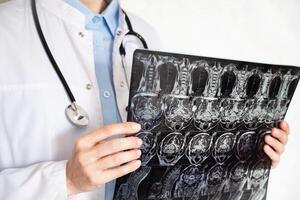 Doctor analyzing medical imaging for patient diagnosis in a clinical setting photo