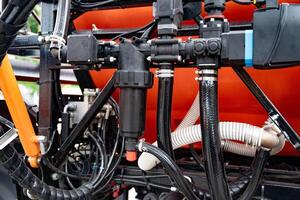 industrial pump with green and black components, orange background. photo