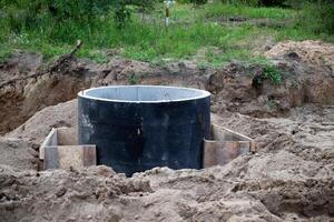 Drainage hole beside a newly paved road . photo