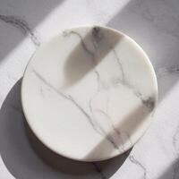 Round marble tray with elegant veining, bathed in natural light and shadow photo