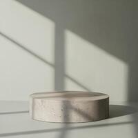 Modern concrete cylindrical podium with natural light and shadow play photo