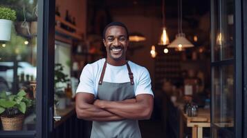 A smiling black man in an apron standing in front of a restaurant photo