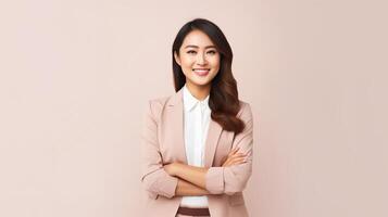 Portrait of asian business woman smiling with arms crossed on pink background photo