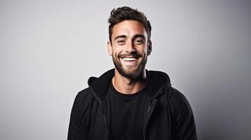 A man with a beard and a black jacket is smiling photo