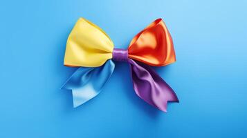 A rainbow colored bow on a blue background photo
