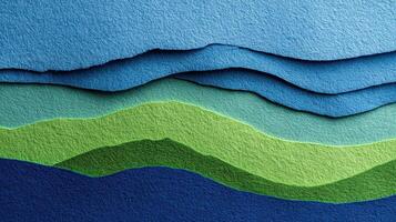 A blue and green paper cut out mountain range photo