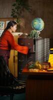 The woman searches for documents in the file cabinet and takes them out of one of the shelves. Working in a retro office photo
