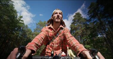 A man and a woman are talking while riding bicycles along the forest. Front view of a man photo
