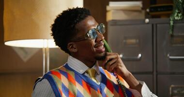 A man is talking on a wired phone. Animated facial expressions on his face. The is getting closer to the face photo