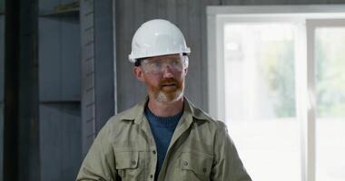 Two men are working intently at a cardboard factory. They check the quality of the cardboard photo