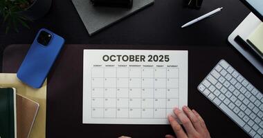 October 2020 calendar on desk with laptop and coffee photo