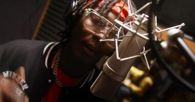 Close-up of a man's face while he recording a song in the studio. He sings into the microphone photo