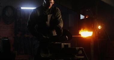 A man is working on a piece of metal photo