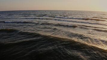 Panoramic view of the sea distance during dawn. Large foamy waves in the sun, from a drone. photo