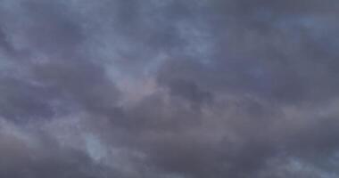 View of the sky covered with gray clouds with a pink reflection of the setting sun. in 4 k, red komodo. photo