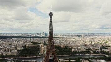 Cityscape of Paris from a bird's eye view. Close-up of the spire of the Eiffel tower overlooking the Seine and the cityscape. France Paris photo