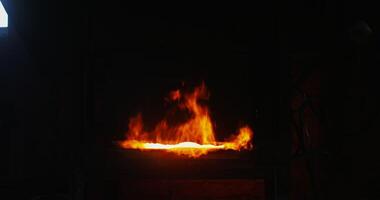 Kindled fire in the blacksmith's furnace, close-up. A strong flame breaks out of the furnace and rises up. There are no people in the . 4k , red komodo photo