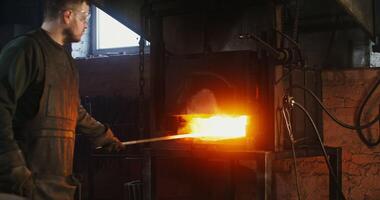 A man is working on a furnace with a torch photo