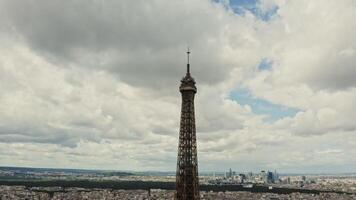 The top of the Eiffel Tower, aerial view from a drone on a cloudy day. The spire of the Eiffel Tower close-up. France Paris photo
