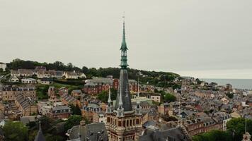 Benedictine palace in F camp in northern France. Bird's-eye , a view of the tower and spire of the palace from a drone. View of the historic city center with traditional houses. photo