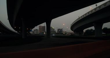 from a car driving along the highway on the outskirts of a modern metropolis with palm trees on the roadsides, shooting at dusk photo