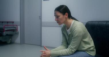 The doctor informs the relatives about the favorable outcome of the operation. They thank him, rejoice and hug, standing in the hospital corridor photo