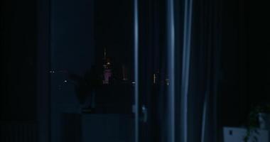 View from the window of the night city. The lights of the skyscrapers of the city center in the dark photo