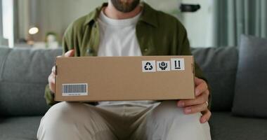 A man is holding a box with a sticker on it photo